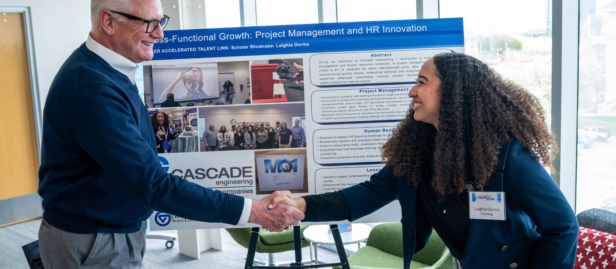 Graduate student shaking someones hand.